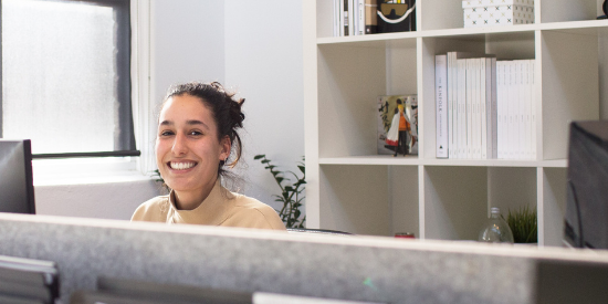 Stock image of a participant smiling at an off-the-shelf course.